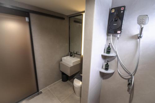 a small bathroom with a shower and a toilet at Near Don Mueang Hotel in Don Muang Airport