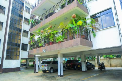 a building with a balcony with plants on it at Stylish 3-bed Ensuite Apt in Westlands in Nairobi