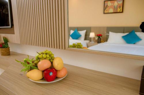 a bowl of fruit on a table in a hotel room at Lanxy Hotel Nha Trang in Nha Trang
