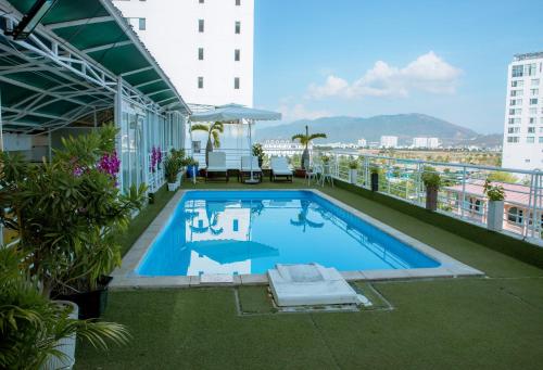 a swimming pool on the roof of a building at Lanxy Hotel Nha Trang in Nha Trang