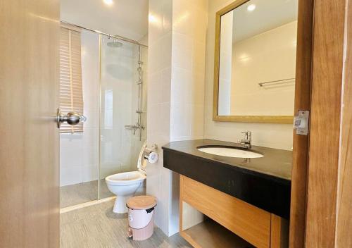 a bathroom with a sink and a toilet and a mirror at Villa 102 - villa 114 royal lotus, Hùng Thắng, Hạ Long, Quảng Ninh in Ha Long