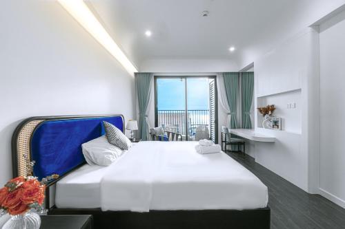 a bedroom with a bed with a view of the ocean at Sole Casa Phu Quoc in Phu Quoc
