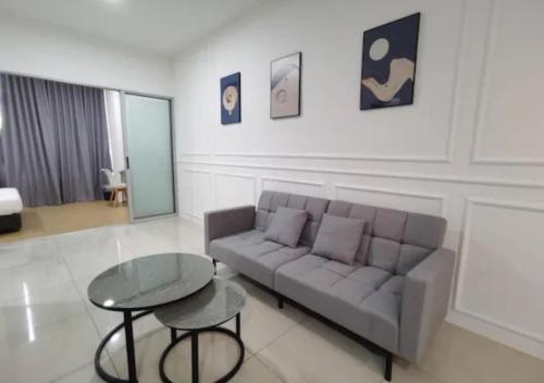 a living room with a couch and a table at ITCC Manhattan by IGVC in Penampang