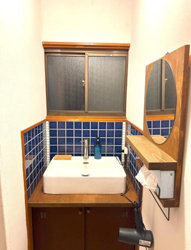 a bathroom with a sink and a mirror at Japan Kominka in perfect location for Mount FUJI trip in Fujiyoshida