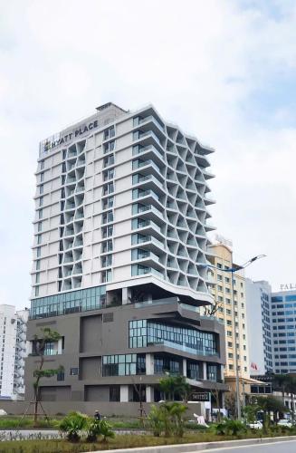 a large white building with a lot of windows at Hyatt Place Ha Long Bay, Bai Chay in Ha Long