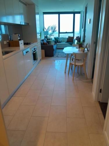a kitchen and living room with a tile floor at Oasis Retreat on Level 71 in Skytower in Brisbane