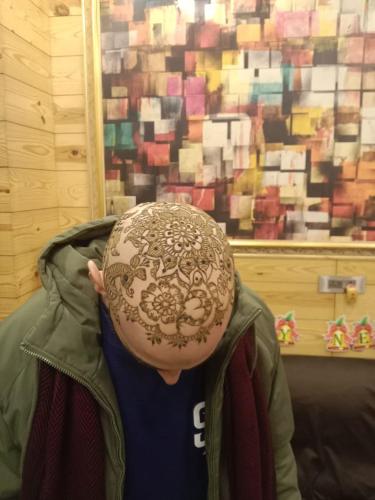 a person with a henna covered hat on their head at Jaipur The Lodge B&B in Jaipur