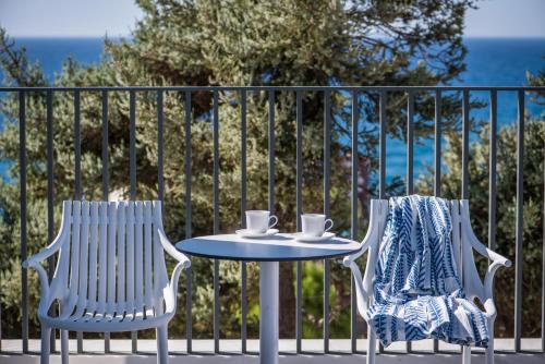 two chairs and a table with two cups on it at Ergina Boutique Experience in Sissi