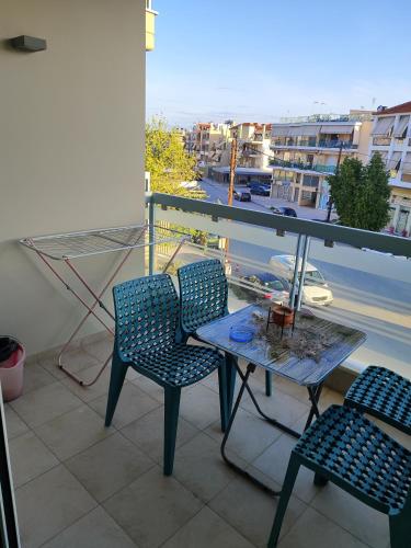 a balcony with a table and chairs and a view of a city at Δροσια 1 in Nafplio