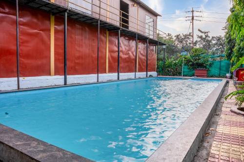 a swimming pool in front of a building at Bhairavnath Resort and Hospitality in Lonavala