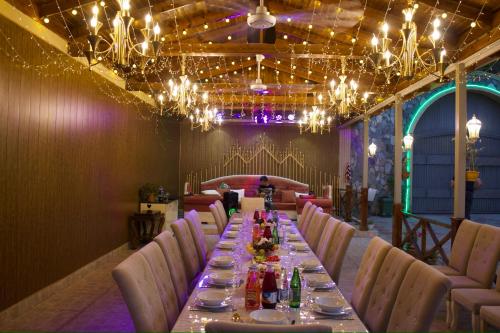 a long table in a room with chairs and lights at Museum Boutique Luxury GH in Sheki