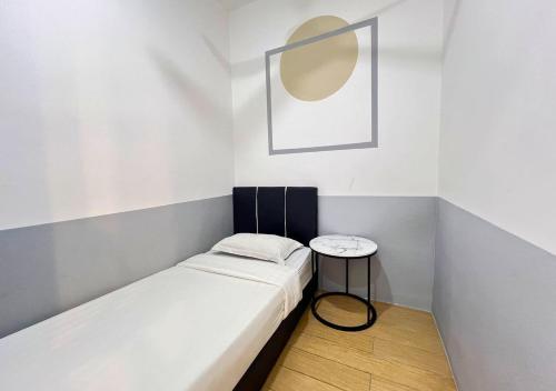 a small room with a bed and a small table at ITCC Manhattan by IGVC in Penampang