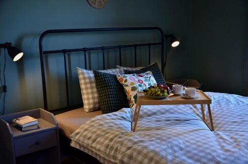a bed with a tray of fruit on top of it at Jcamp in Nové Město pod Smrkem
