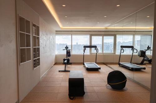 a gym with treadmills and exercise equipment in a building at Eliena Hotel Seoul Gangnam in Seoul