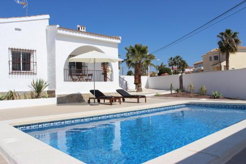 a swimming pool in front of a house at Casa Giner in Ciudad Quesada