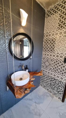 a bathroom with a sink and a mirror at Kajal Kiin in El Cuyo