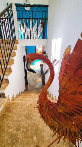 a statue of a statue of a bird on a staircase at Kajal Kiin in El Cuyo