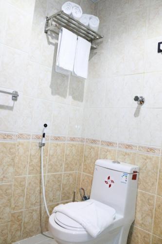 a bathroom with a toilet and towels in it at Elaf Ajyad Hotel Makkah in Makkah