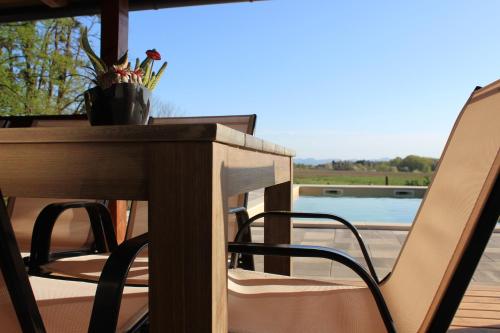 a table and a chair on a porch with a table and a table at Villa Green Relax in Gornji Mihaljevec