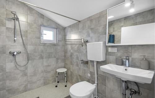 a bathroom with a toilet and a sink and a shower at Holiday Home Murter 18 With Seaview in Murter