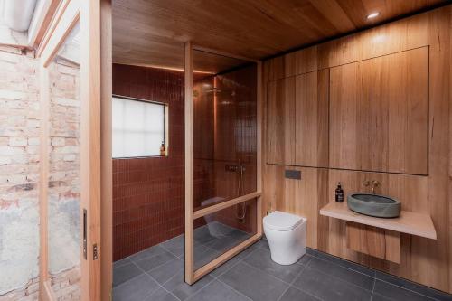 a bathroom with a toilet and a shower and a sink at Richmond 1823 in Richmond