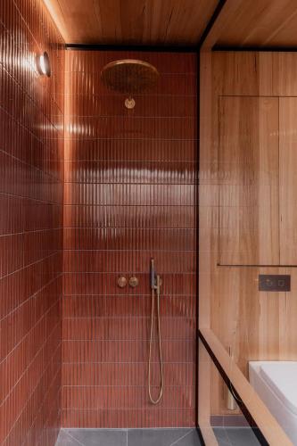a bathroom with a shower with red tile at Richmond 1823 in Richmond