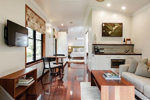 a living room with a couch and a table at Spicers Tamarind Retreat in Maleny