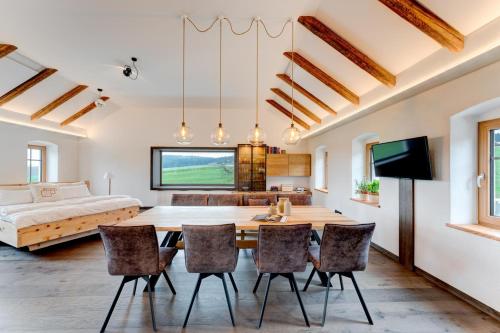 a dining room and living room with a table and chairs at Außergewöhnliches Loft Senftenbach in Senftenbach