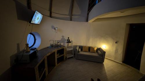 a living room with a couch and a television at Kajal Kiin in El Cuyo