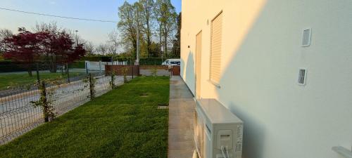 a building with a yard next to a fence at Casa STELLA in Mirano