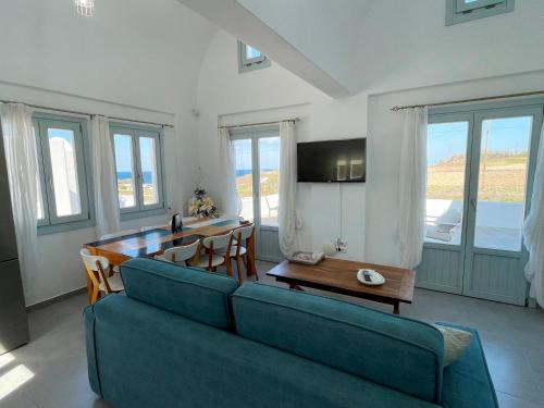 a living room with a couch and a table at SAND villa in Monolithos