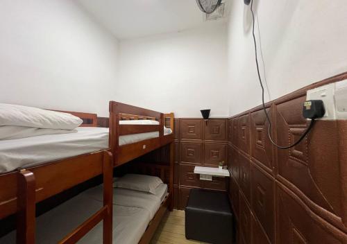 a small room with two bunk beds in it at ITCC Manhattan by IGVC in Penampang