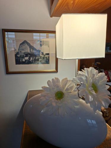 a blue vase with flowers in it on a table at Landgasthof Zum Engel in Angelbachtal