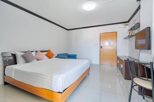 a bedroom with a bed and a television in it at One Residence Navanakorn in Pathum Thani