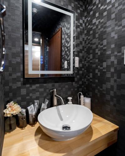 a bathroom with a white sink and a mirror at ohayo両国 in Tokyo