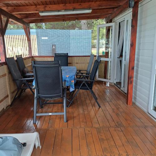 a porch with chairs and a table on it at Vila Matias in Vodice