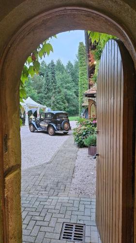 an archway with a car parked in a driveway at Le Château du Landsberg in Barr
