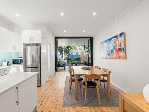 a kitchen and dining room with a table and chairs at The Mitchell Bondi in Sydney