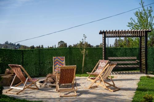 a group of chairs sitting on a patio at Akhalsheni House in Batumi