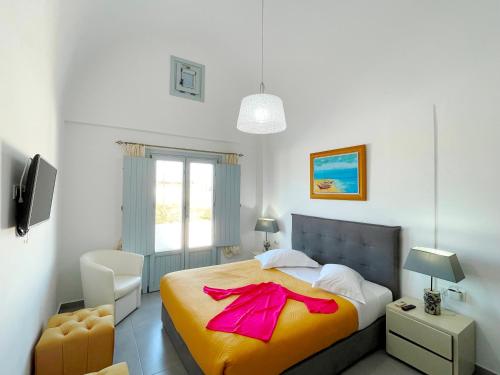 a bedroom with a bed with a pink bow on it at SEA and SAND villa in Monolithos