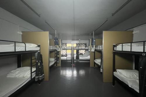 a room with several bunk beds in it at Makotel Hostel Ipoh in Ipoh