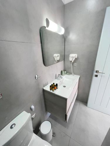 a bathroom with a sink and a toilet and a mirror at SEA and SAND villa in Monolithos