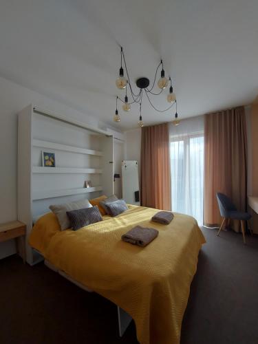 a bedroom with a large bed with two towels on it at VIGEO lounge b&b coffee in Bojnice