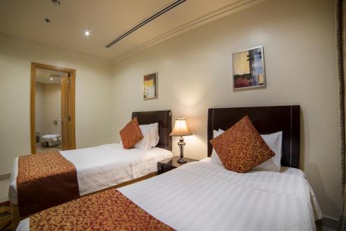 Llit o llits en una habitació de Al Rashid Residence