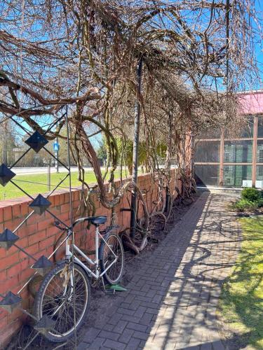 a bike parked next to a brick wall at Park Hotel Kekava in Ķekava