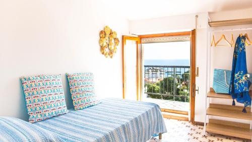 a bedroom with a bed with a view of the ocean at Attico Orizzonte, splendida vista sul golfo IUN T2810 in Cala Gonone
