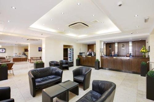 a lobby of a hospital with chairs and a waiting room at Queens Park Hotel in London