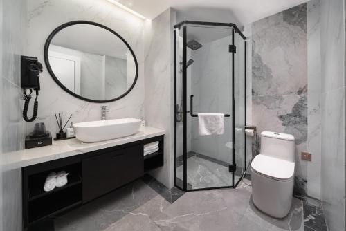a bathroom with a toilet and a sink and a mirror at 22 Land Hotel in Hanoi