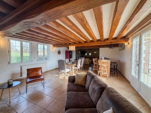 a living room with a couch and a table at La longère de Guitôt in La Ferté en Ouche
