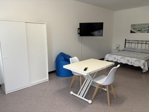a room with a table and two chairs and a bed at Solarolo Village in Moneglia